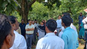 Director interacting with farmers in the field